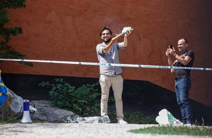 A demonstrator burns the Koran outside Stockholm's central mosque in Stockholm, Sweden June 28, 2023. TT News Agency/Stefan Jerrevang/via REUTERS