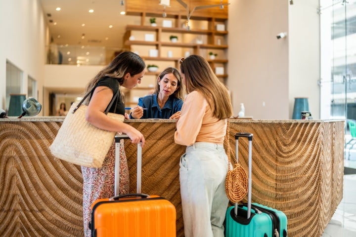 Hotel receptionist talking customers at lobby