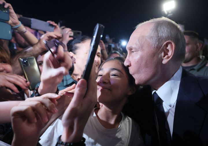 Russian President Vladimir Putin kisses the head of one of the residents of Derbent.