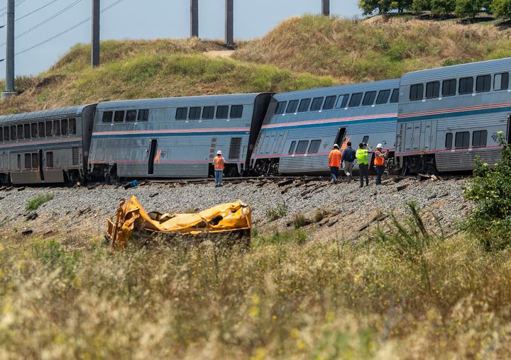 Investigators examine the scene of an Amtrak train that derailed after colliding with a water tank truck in Moorpark.