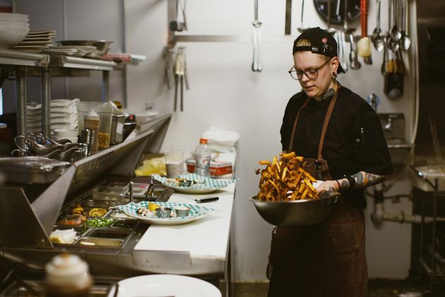 Renton Sinclair tosses fries in the kitchen of the restaurant he co-owns in Kansas City.
