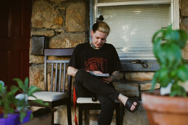 Renton Sinclair reads through his old diary on his porch in Kansas City.