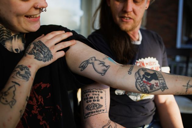 Renton Sinclair shows his white rabbit tattoo on his porch in Kansas City.