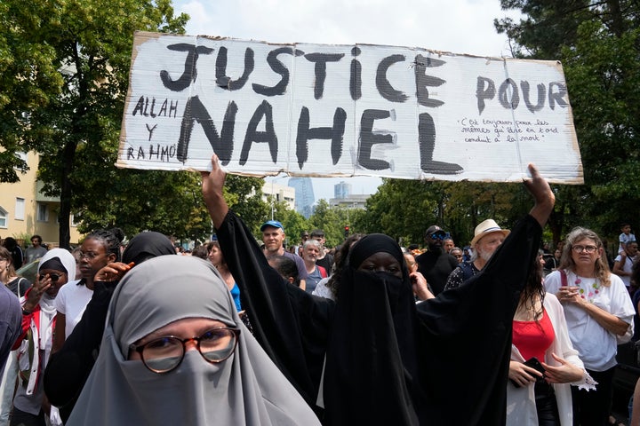 A woman shows a poster 