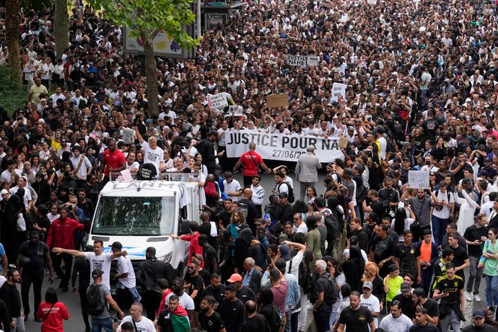 The mother of killed 17-year-old Nahel, at left on truck, gestures during a march for Nahel, Thursday, June 29, 2023 in Nanterre, outside Paris.