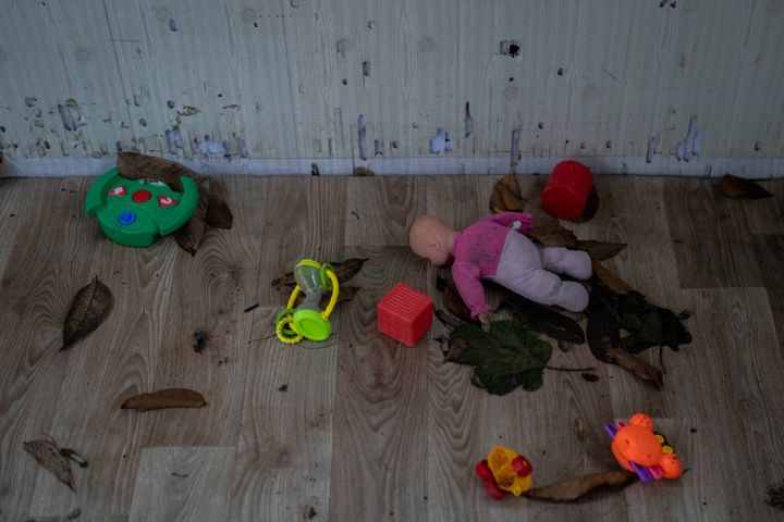 Toys and a doll lay on the floor of a playhouse in the courtyard of Kherson regional children's home in Kherson, southern Ukraine, Friday, November 25, 2022.