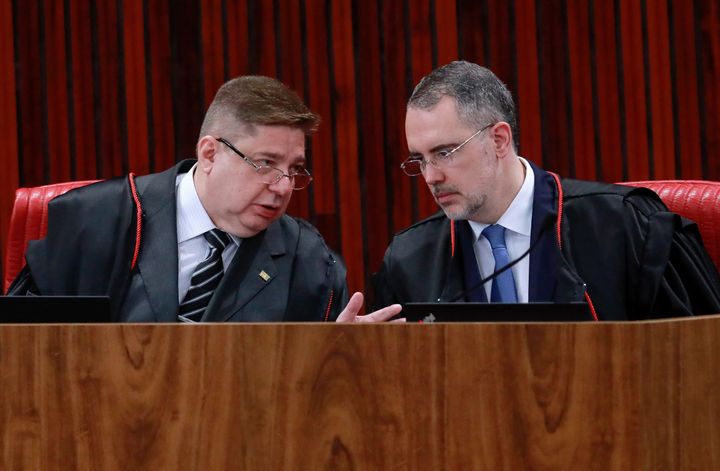 Brazil's Superior Electoral Court judges Raul Araujo (L) and Andre Ramos Tavares (R) speak during the start of the trial of former President (2019-2022) Jair Bolsonaro, accused of abuse of power and misinformation, in Brazil, on June 27, 2023. 