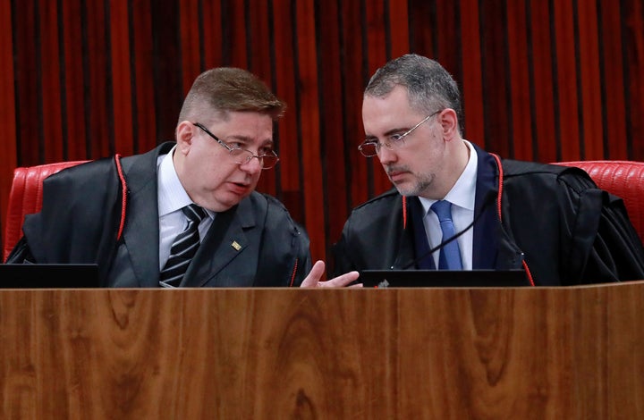 Brazil's Superior Electoral Court judges Raul Araujo (L) and Andre Ramos Tavares (R) speak during the start of the trial of former President (2019-2022) Jair Bolsonaro, accused of abuse of power and misinformation, in Brazil, on June 27, 2023.