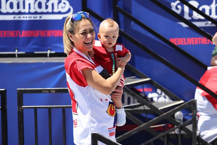 Miki Sudo with her son Max at the 2022 Nathan's contest.