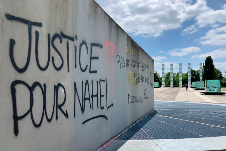 A graffiti reads "Justice for Nahel" on a wall Sunday, July 2, 2023 in Paris suburb Nanterre. A monument commemorating Holocaust victims and members of the French resistance during World War II in Nanterre was still defaced with graffiti Sunday, after it has been vandalized Thursday on the margins of a silent march to pay tribute to Nahel. Vandals painted anti-police slogans including "Police scum from Saint-Soline to Nanterre," "Don't forget or forgive," and "Police, rapists, assassins" (AP Photo/Cara Anna)