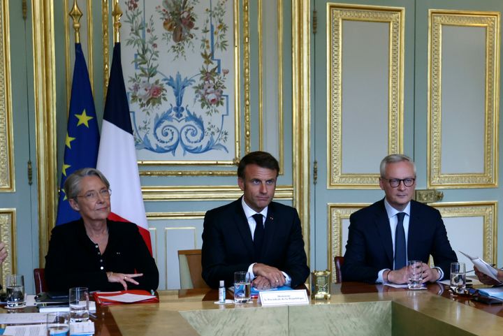 French President Emmanuel Macron, center, French Prime Minister Elisabeth Borne, left, and Economy Minister Bruno Le Maire attend a government emergency meeting at the emergency crisis center of the Interior Ministry in Paris, on July 2, 2023 after a 17-year-old whose killing by police has triggered days of rioting and looting across the nation. 