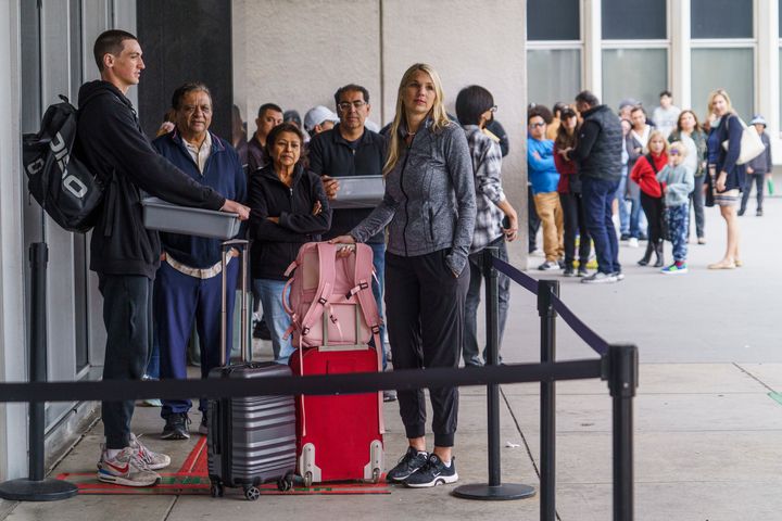Marni Larsen and her son, Damon Rasmussen of Holladay, Utah, wait their turn in line hoping to snag her son's passport outside the Los Angeles Passport Agency at the Federal Building in Los Angeles on June 14, 2023. Larsen applied for her son's passport two months earlier and spent weeks checking for updates online or through a frustrating call system. 