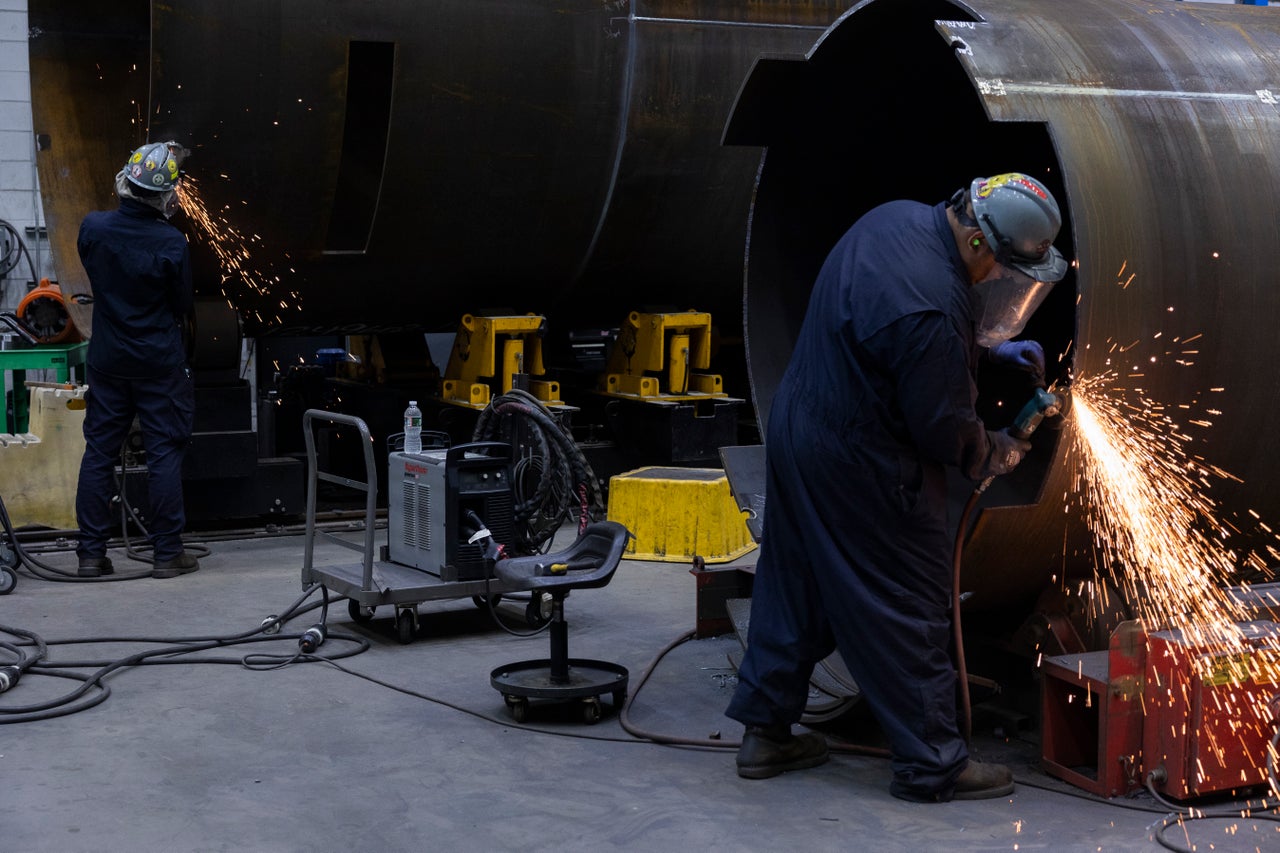 Workers are seen at the Holtec headquarters in Camden.