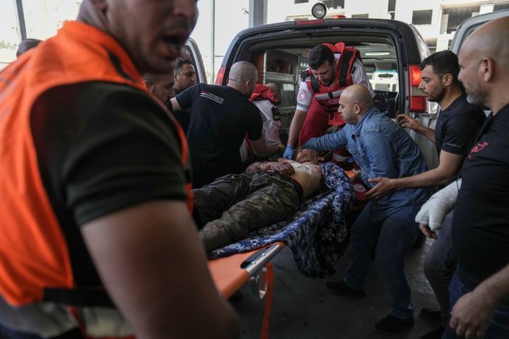 An injured Palestinian is carried into a hospital during an Israeli military raid in the Jenin refugee camp, a militant stronghold in the occupied West Bank, Monday, July 3, 2023. (AP Photo/Nasser Nasser)