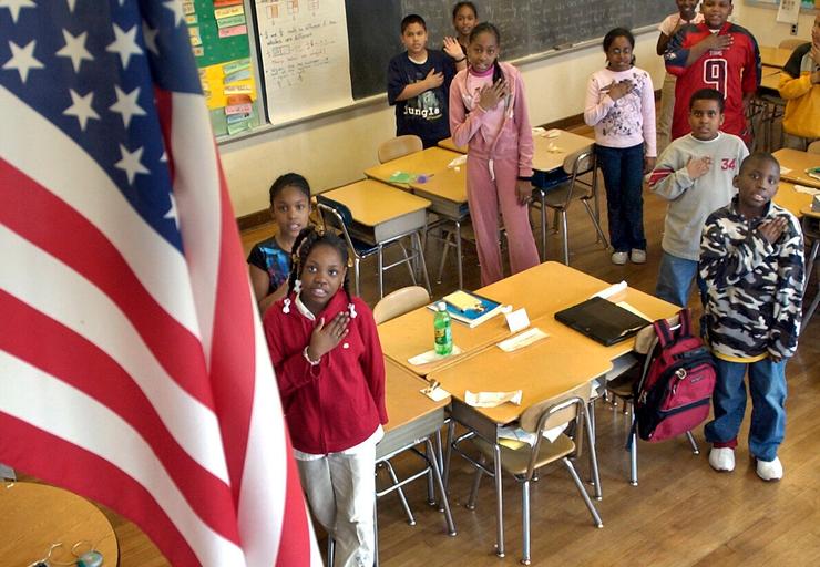 Fourth graders at Charles H. Taylor Elementary School in Boston recite the Pledge of Allegiance on March 24.