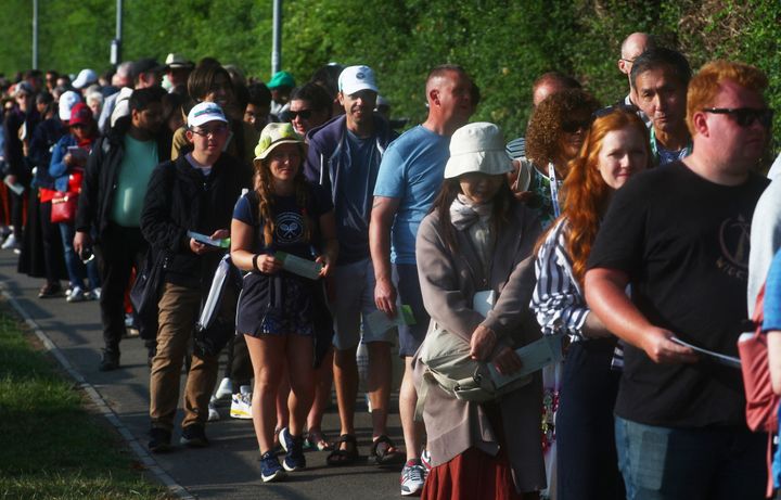 People wait in the queue on the first day of Wimbledon.