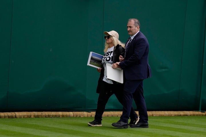 A Just Stop Oil protester is removed from Court 18 on day three of the Wimbledon tennis championships in London, on July 5, 2023.