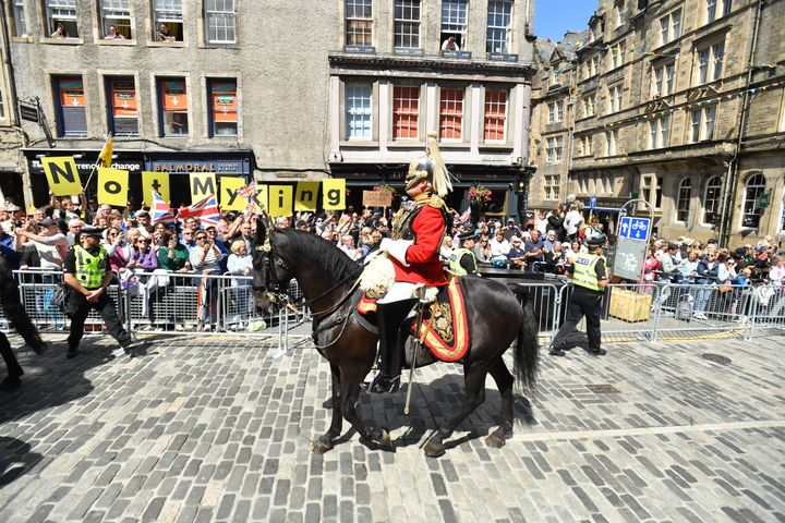 The royal procession makes its way up the Royal Mile in Edinburgh to St Giles' Cathedral.