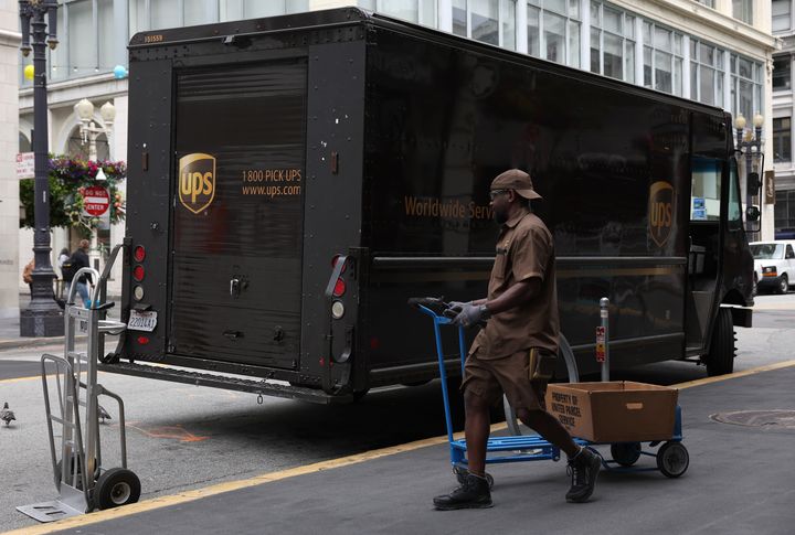 A UPS driver pulls a cart up to his truck while making deliveries on June 12, 2023, in San Francisco, California. More than 330,000 UPS union workers are voting to authorize a strike against UPS. The Teamsters union is seeking higher wages and benefits as well as work condition improvements that include retrofitting 95,000 delivery trucks to have air conditioning. If the workers vote to strike, it would be the largest single-employer strike in U.S. history.