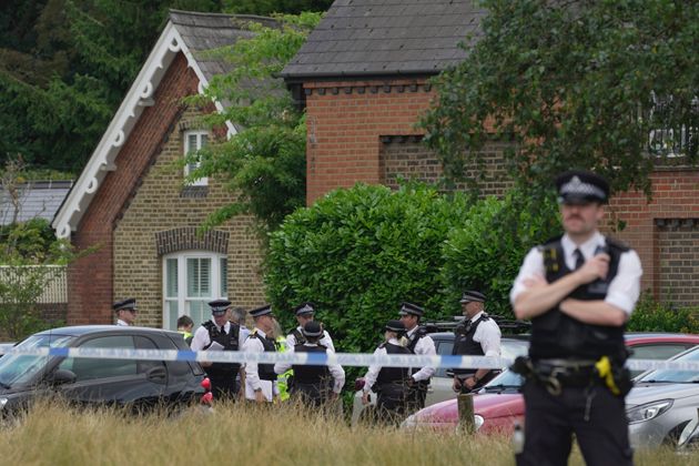 Police officers set up cordon line as a car crashed into a primary school building in Wimbledon, London.