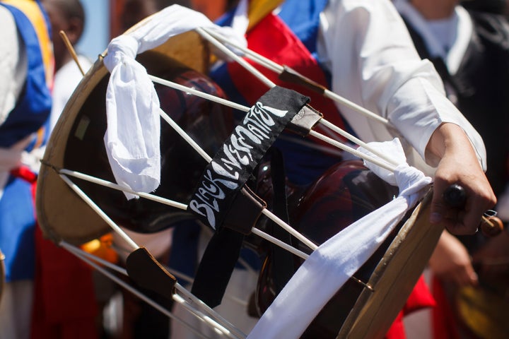 "Black Lives Matter" is written on the drum of a Korean musician at a peace rally on the 25th anniversary of the LA uprising.