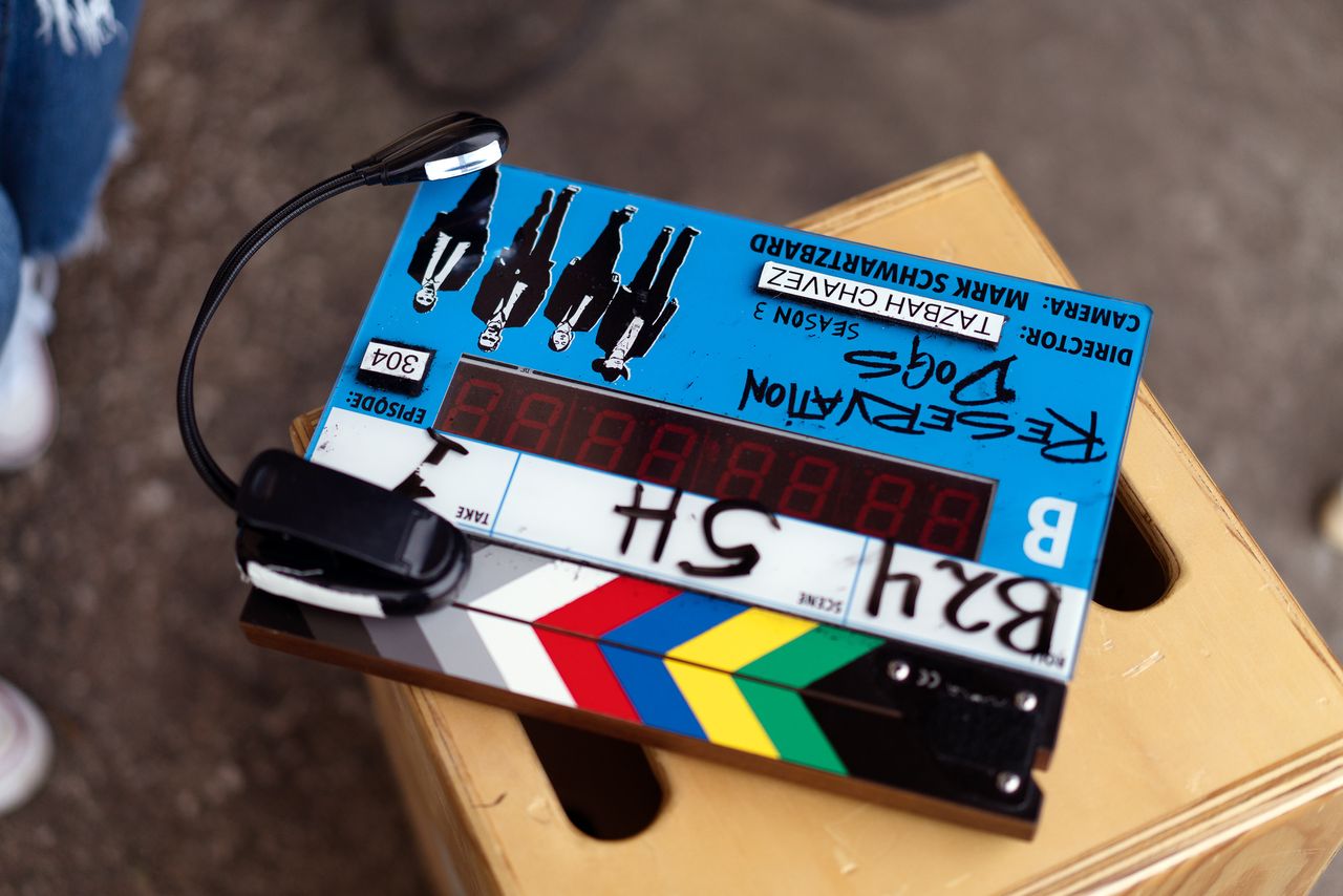 A "Reservation Dogs" clapperboard sits on an apple box.