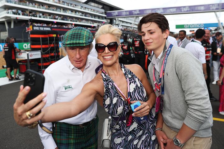 Hannah Waddingham takes a selfie with Sir Jackie Stewart on the grid prior to the F1 Grand Prix of Great Britain at Silverstone Circuit on July 9