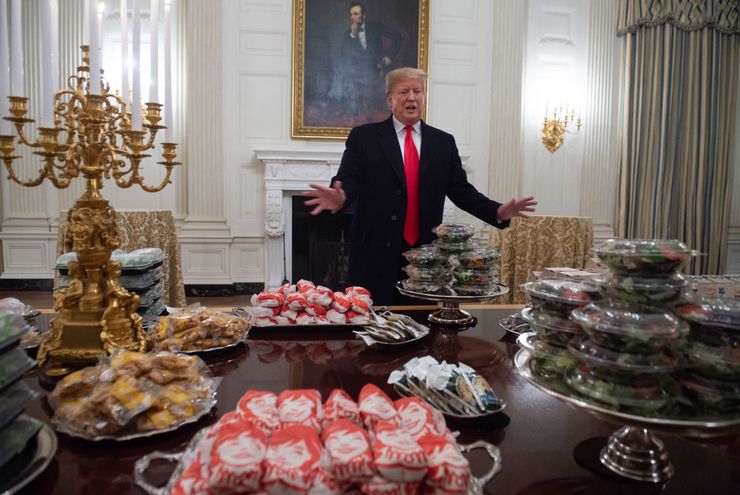 President Donald Trump speaks alongside fast food purchased for a ceremony honoring the 2018 College Football Playoff National Champion Clemson Tigers at the White House on Jan. 14, 2019.