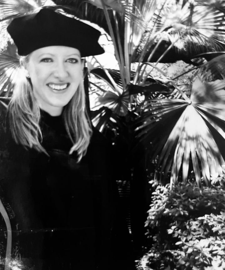 The author poses at her law school graduation in 2005.