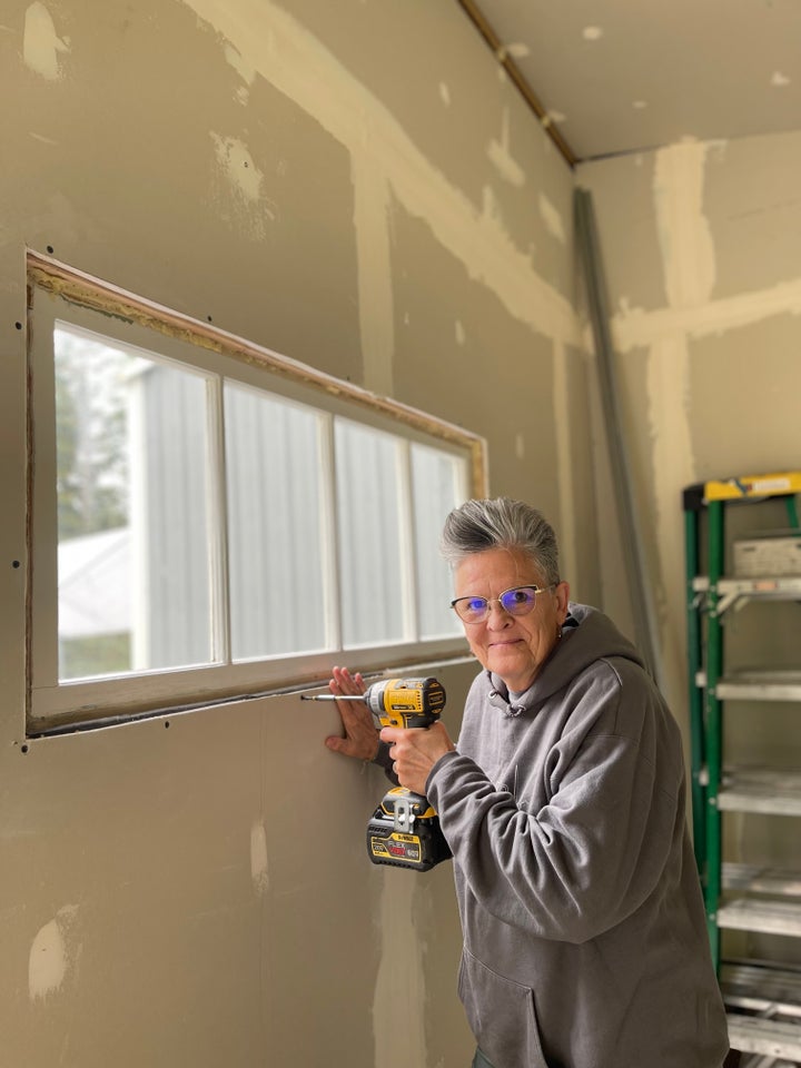 The author working on her own renovation project of turning a shed into a writing room.