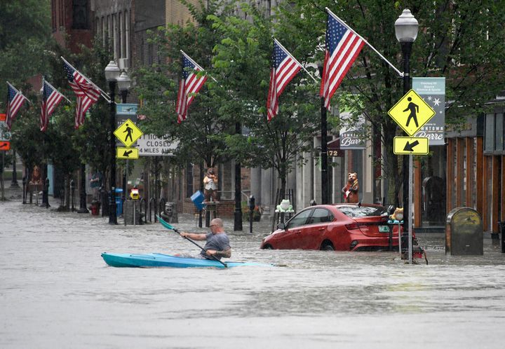 A kayaker paddles across Main Street in downtown Barre, Vermont., on Monday night, July 10, 2023.