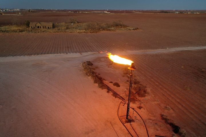 In an aerial view, natural gas is flared off during an oil drilling operation in the Permian Basin oil field on March 12, 2022, in Stanton, Texas.