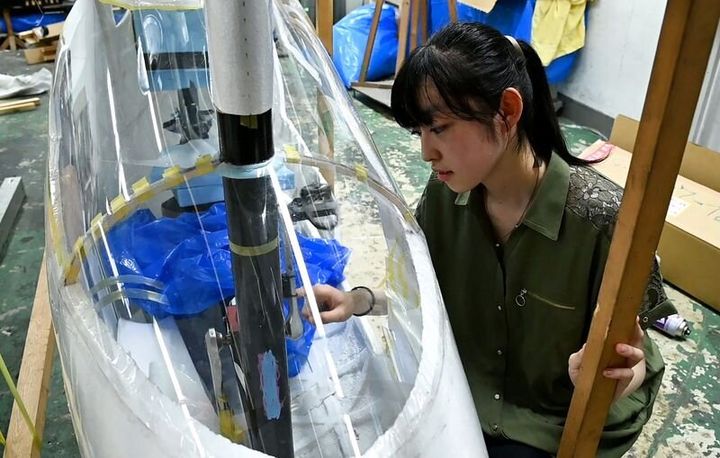 Yuna Kato works with her college club to produce a light human-powered aircraft at Tokyo University in Tokyo, June 30, 2023, in this screen grab from video. REUTERS/Chris Gallagher