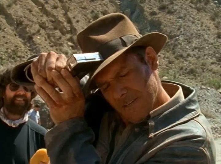 Harrison Ford was seen stapling Indiana Jones' fedora to his head in a BTS clip
