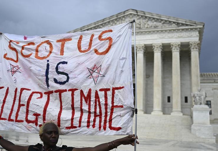 People rally outside the U.S. Supreme Court on June 29 to protest recent decisions to strike down a student loan forgiveness plan and bar race-conscious student admissions programs.