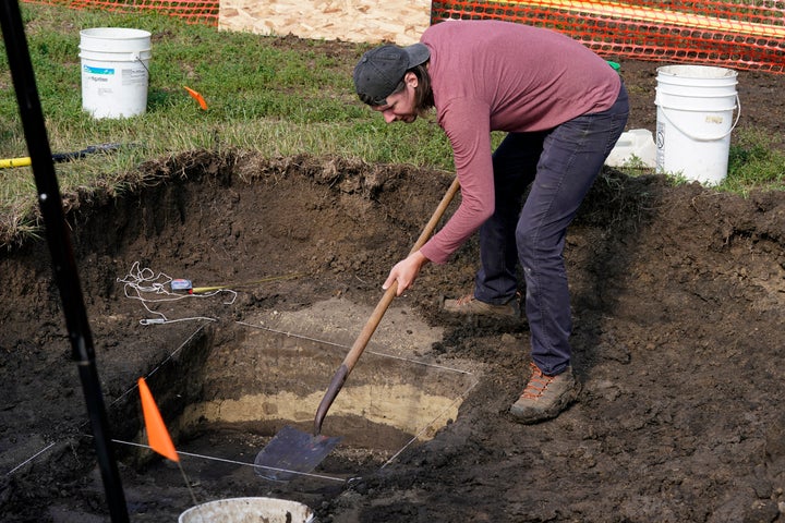 Archeological technician Makenzie Coufal clears soil away as workers dig for the suspected remains of children who once attended the Genoa Indian Industrial School, on Tuesday, July 11, 2023, in Genoa, Neb.