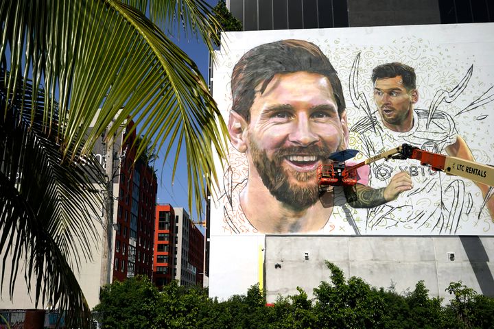 Artist Maximiliano Bagnasco paints a mural of Argentine soccer star Lionel Messi in the Wynwood neighborhood of Miami.