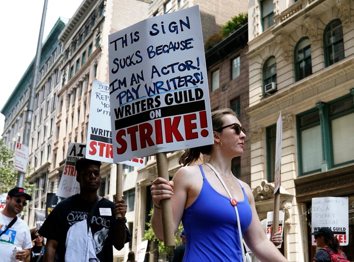 Members of the Writers Guild of America and the Screen Actors Guild walk a picket line outside of Warner Bros. in New York on July 13, 2023. Actors were poised to go on strike July 13, joining writers in the first industry-wide shutdown in 63 years after last-ditch talks failed, with nearly all film and television production likely to grind to a halt. SAG-AFTRA, which represents 160,000 performers including A-list stars, said negotiations late July 12 had ended without a deal.