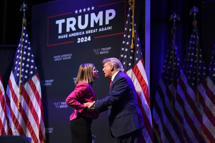 Former President Donald Trump is greeted by Iowa Gov. Kim Reynolds as he arrives for an event at the Adler Theatre on March 13, 2023, in Davenport, Iowa. Trump's visit follows those by potential challengers for the GOP presidential nomination, Florida Gov. Ron DeSantis and former U.N. Ambassador Nikki Haley, who hosted events in the state last week. 
