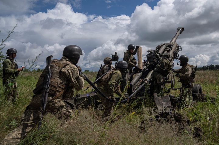 Ukrainian servicemen prepare to fire at Russian troops using a U.S.-supplied howitzer in the Kharkiv region of Ukraine in July 2022. The House rejected efforts to cut off such aid in part or completely in votes on Thursday.
