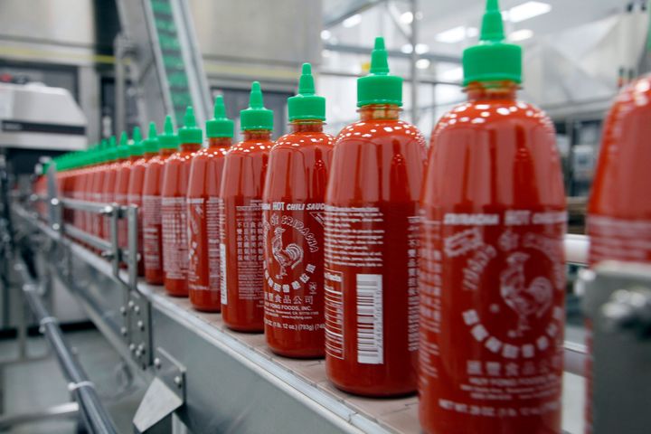 FILE - In this 2013 file photo, Sriracha chili sauce is produced at the Huy Fong Foods factory in Irwindale, California. Underwood Ranches, which now sells its own brand of Sriracha, started producing red jalapeño peppers again this year — in part because of the Huy Fong shortage, according to Underwood Ranches owner Craig Underwood.