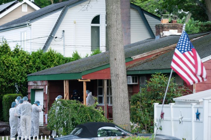 Crime laboratory officers arrive on Friday to the Massapequa Park, New York, house where a suspect has been taken into custody in connection with a long-unsolved string of killings, known as the Gilgo Beach murders. 