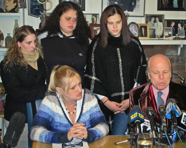 Sarra Elizabeth Gilbert, center, is shown in 2016 standing between her sisters Stevie Smith, left, and Sherre Gilbert, right, as her mother Mari Gilbert, seated left, and attorney John Ray, seated right, hold a press conference about Shannan Gilbert, whose remains led to the discovery of 10 sets of human remains strewn along Long Island’s Gilgo Beach.