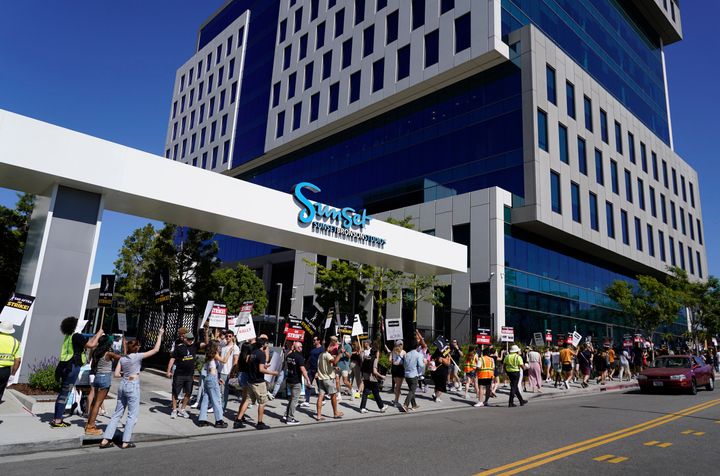 Striking writers and actors rally outside Sunset Bronson Studios in Los Angeles.