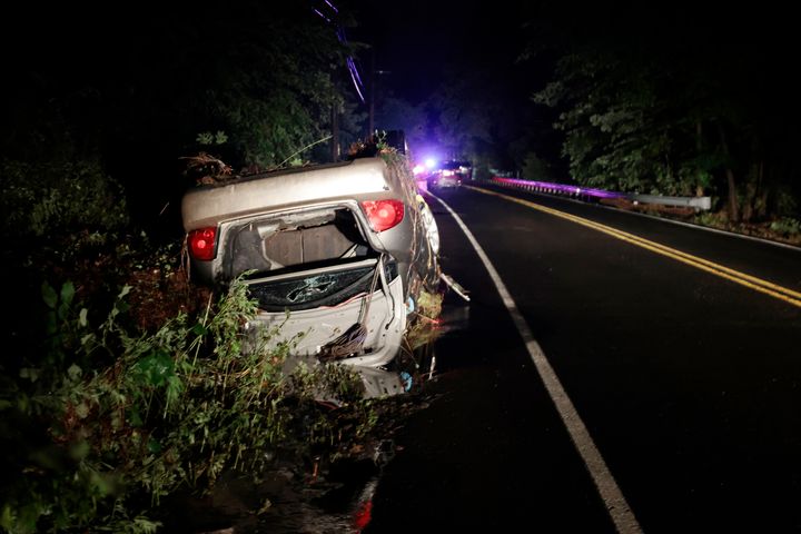 One of the cars that was swept up in flooding that occurred on Washington Crossing Rd., near Houghs Creek, in the Washington Crossing, Pa. area on Sat. July 15, 2023. Several people were killed when torrential rains in area cause fast rising floodwaters washing away cars. (Elizabeth Robertson/The Philadelphia Inquirer via AP)