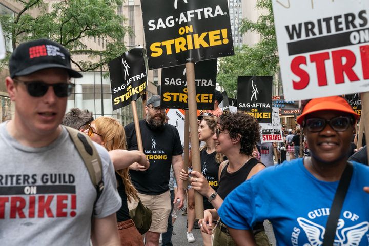 Members of the WGA and SAG-AFTRA rally on a picket line at Rockefeller Center in New York on Friday. 