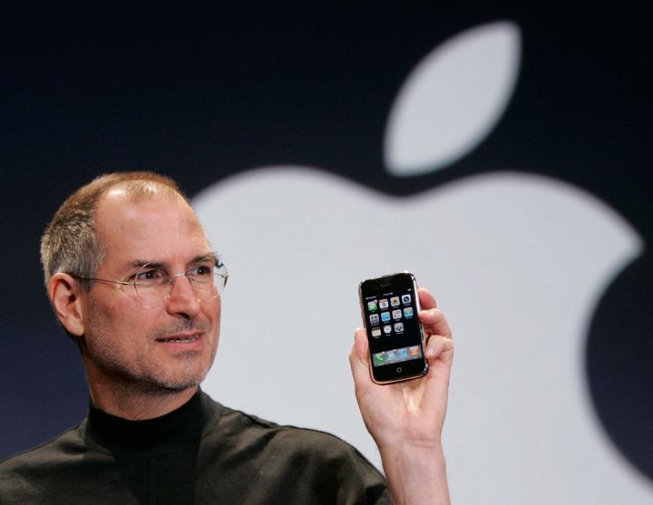 Apple CEO Steve Jobs holds up an Apple iPhone at the MacWorld Conference in San Francisco on Jan. 9, 2007. (AP Photo/Paul Sakuma)