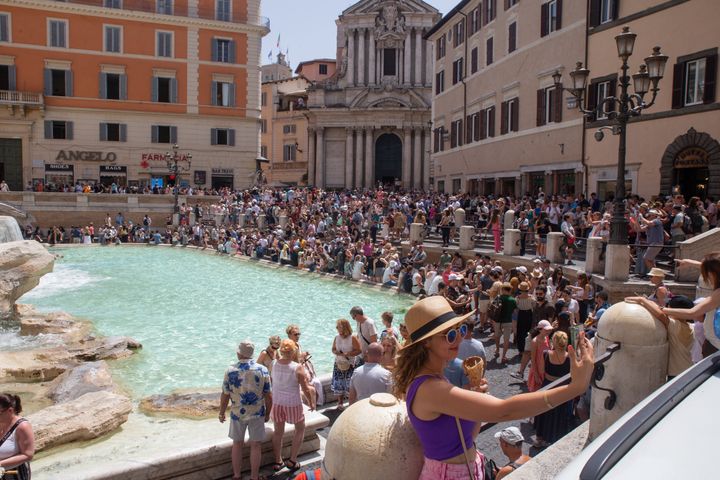 ROME, ITALY - 2023/07/17: A woman takes a selfie with an ice cream in front of Trevi Fountain on a hot summer day. (Photo by Matteo Nardone/Pacific Press/LightRocket via Getty Images)