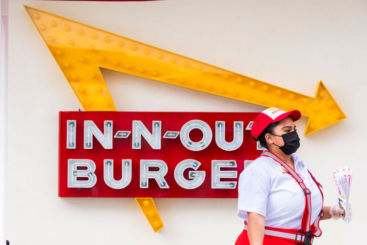 A masked In-N-Out employee works at the Santa Ana, California, location on April 1, 2021.