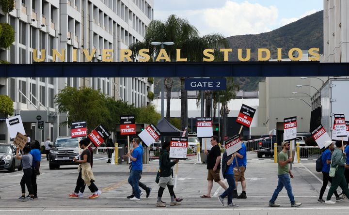 Members of the Writers Guild of America picket outside of Universal Studios on May 3. Union members suspect that the studio trimmed trees along a sidewalk where they have regularly picketed, preventing them from receiving shade, as temperatures heat up. 